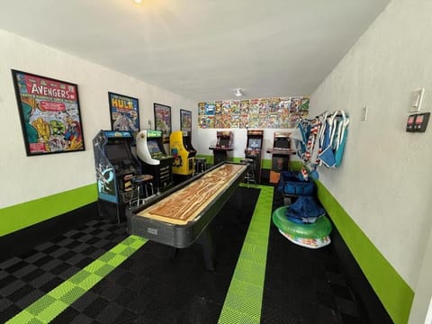 Your personal arcade awaits with classic games, shuffleboard, and comic book art creating the ultimate entertainment retreat.