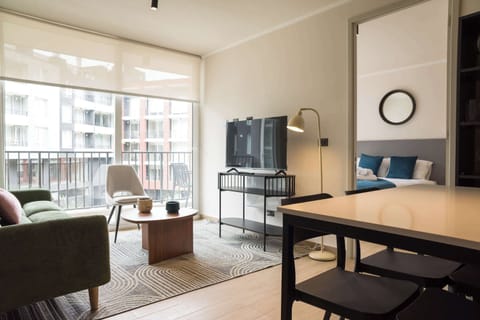 Bright and cozy living area with modern furnishings and a view, perfect for relaxation.