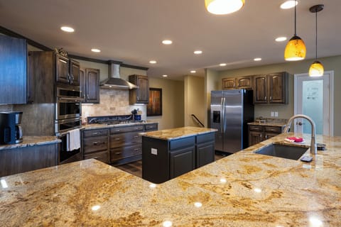 You'll love cooking in this spacious gourmet kitchen with granite counters, center island, and stainless appliances.