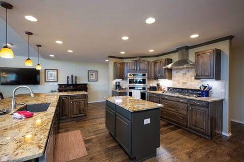 Your gourmet kitchen awaits with granite countertops, stainless steel appliances, and an island perfect for cooking memorable meals together.