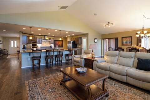 Relax in your spacious open-concept living area, where plush seating flows seamlessly into a gourmet kitchen perfect for entertaining.