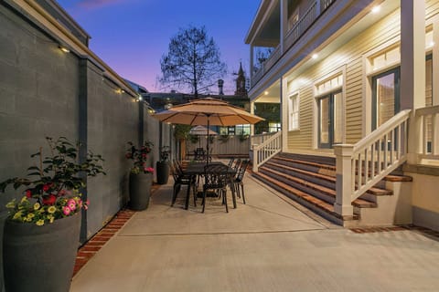 Backyard seating area on the side of the home at twilight