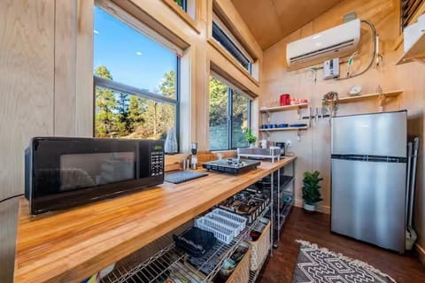 Basic kitchen utensils, a small fridge/freezer, microwave & 2-burner hot plate.