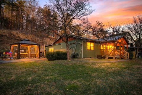 Surrounded by trees and hillside views, the home offers a peaceful Smoky Mountains setting with multiple outdoor living areas to enjoy year-round.