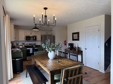 Open concept dining room, kitchen, pantry and sliding back door to the large deck and backyard