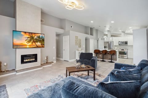 Open layout living room with electric Fireplace, L-Shaped Sofa, and Smart TV