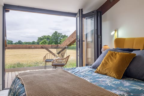 1 Long Barn, Henham: Master bedroom with balcony featuring views across the surrounding fields
