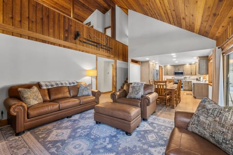 Relax in your cozy leather seating while warm wood beams frame your mountain retreat's open living space.