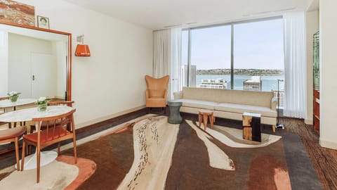 Lounge by panoramic windows and savor the waterfront skyline.