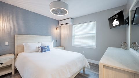 Unwind in crisp linens with TV and coastal calm.