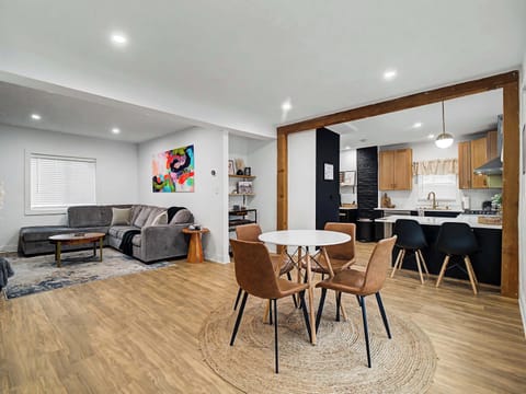 Open dining area w/ wood table flowing seamlessly into the kitchen