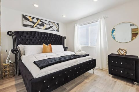 Bright and airy bedroom with modern furnishings and a soft, inviting bed