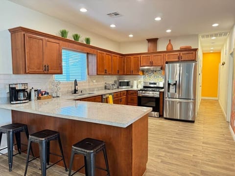 Chefs Kitchen overlooking dining and living room, with a massive desert murals backdrop
