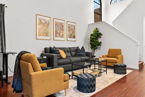 A stylish conversation area with comfortable seating and soaring ceilings creates an inviting place to gather, swap stories from the day, or tune in to the excitement of the World Cup. ⚽