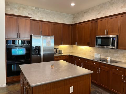 Your chef will love prepping and serving home cooked meals in kitchen with island and 2 ovens.