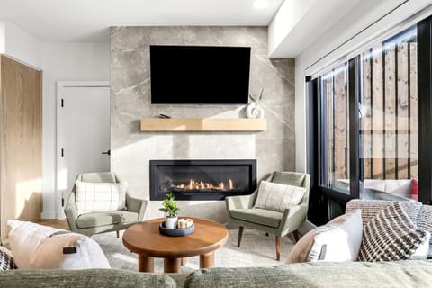 Cozy living area with TV and fireplace.