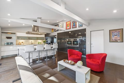 Cozy secondary lounge with fireplace and direct patio access—ideal for quieter moments or a change of scenery.