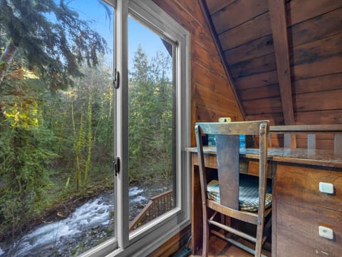 Wake to the gentle sound of rushing water through your window, with cozy bunks perfect for a forest adventure.
