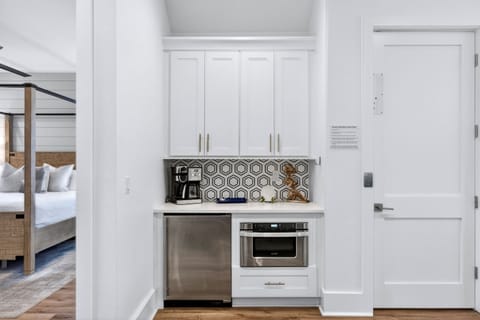 1st floor - entertainment lounge with plush seating, poker table, and a wet bar with fridge, microwave, and coffee maker—plus direct walk-out access to the pool deck for seamless indoor-outdoor living and easy poolside fun.