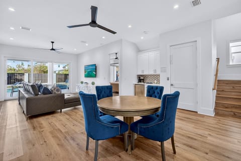 1st floor - entertainment lounge with plush seating, poker table, and a wet bar with fridge, microwave, and coffee maker—plus direct walk-out access to the pool deck for seamless indoor-outdoor living and easy poolside fun.