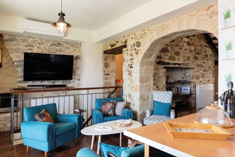 Bright living area featuring a TV, sofa, and coffee table.