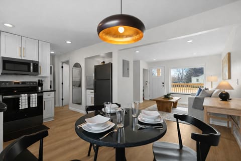 Open-concept dining and kitchen area with modern finishes, warm lighting, and seamless flow into the living space—perfect for meals, entertaining, and relaxing together.