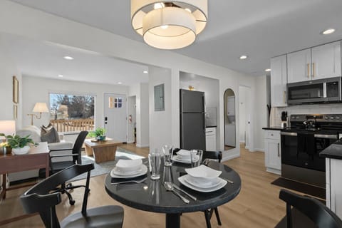 Open-concept living and dining area with modern kitchen, stylish lighting, and cozy seatingâbright, spacious, and designed for comfort and connection.