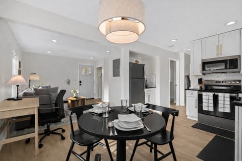 Open-concept dining and kitchen area with modern finishes, stylish lighting, and seamless flow into the living space—perfect for dining, working, and relaxing.
