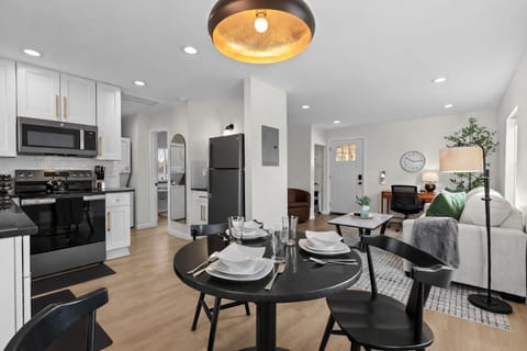 Open-concept living and dining space with modern finishes, stylish seating, and warm lighting—ideal for relaxing evenings or hosting memorable meals.