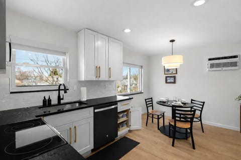 Cook and dine with ease in this modern kitchen featuring sleek finishes, ample counter space, and a sunny dining area perfect for everyday meals.