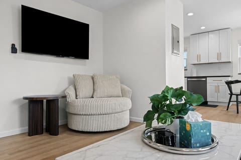 Cozy lounge nook with plush seating, large smart TV, and stylish accents—perfect for unwinding, movie nights, or enjoying a quiet moment indoors.