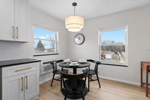 Bright dining nook with modern table seating, natural light, and stylish lighting—perfect for casual meals, coffee breaks, or planning the day ahead.