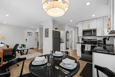 Modern, fully equipped kitchen with sleek appliances, stylish cabinetry, and a cozy dining area—perfect for cooking, dining in, or hosting relaxed meals together.
