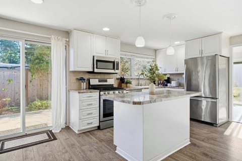 Fully equipped modern kitchen with sleek appliances, ample counter space, and everything you need to cook with ease.