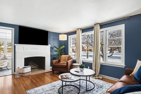 Cozy main living area with natural light and ornamental fireplace
