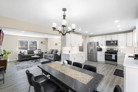 Modern open-plan area designed for relaxing, dining, and cooking all in one space