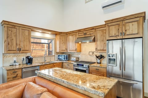 Functional kitchen with stainless steel finishes.