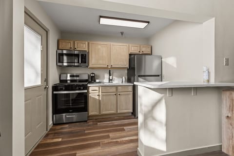 Full kitchen with breakfast bar and modern appliances