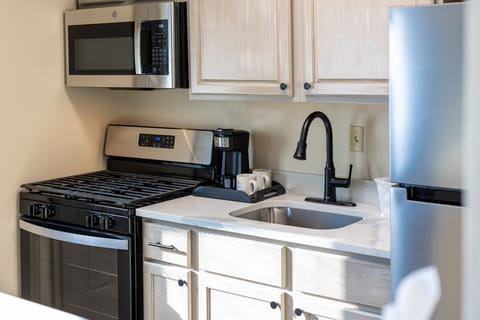 Full kitchen with breakfast bar and modern appliances