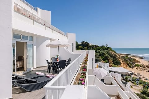 Unwind on sun loungers with sweeping cliffside ocean views.