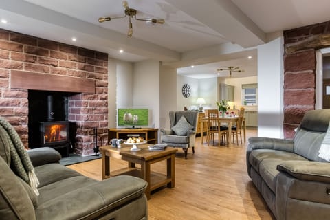 The cosy main sitting room boasting a wood burning stove