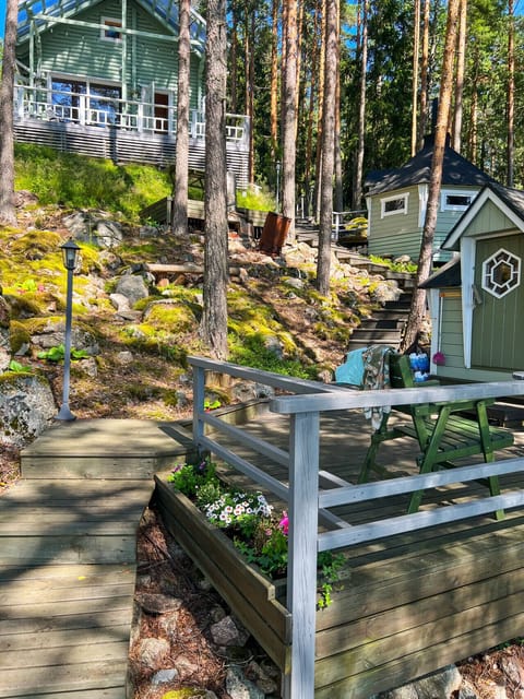 A charming wooden walkway leads you through the lush greenery from the main cottage down to the sauna and lakeshore.