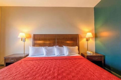 Drift off in a cozy, inviting bed with warm lighting.