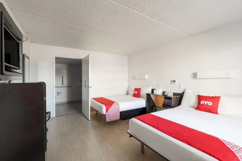Enjoy a straightforward setup with TV, desk, and comfy beds.