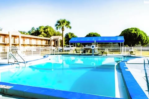 Dive into sunlit relaxation with a sparkling, spacious outdoor pool.