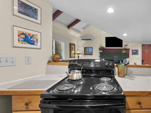 Your fully equipped kitchen invites culinary adventures with modern appliances and charming artwork creating a warm, homey atmosphere.