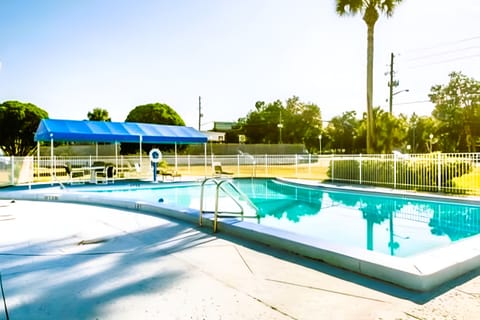 Lounge poolside under open skies for an easy afternoon unwind.