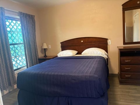 Unwind in a cozy bed with soft lighting and privacy.