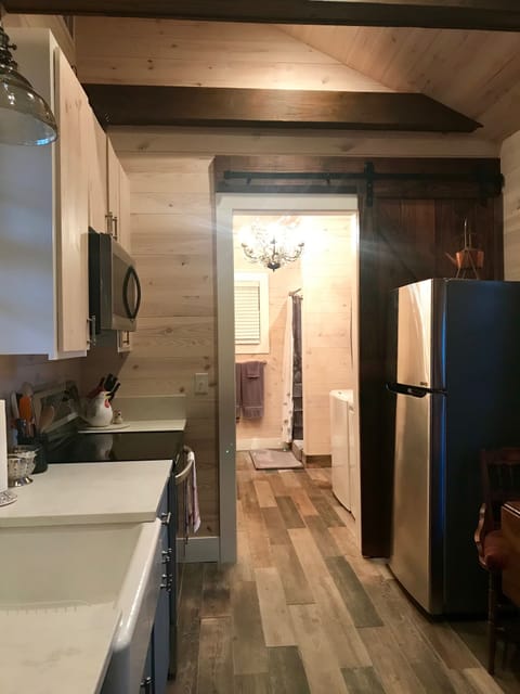 Kitchen with dining table, stove, oven, microwave, and refrigerator.
