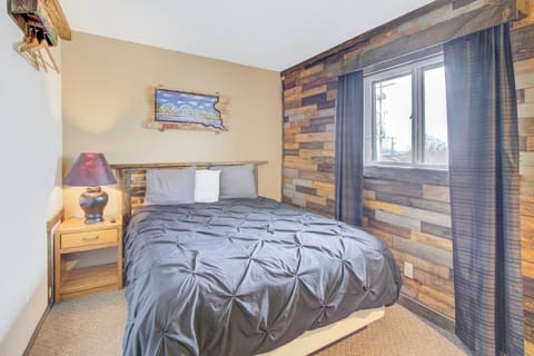 Sink into a cozy bed framed by rustic woodwork.